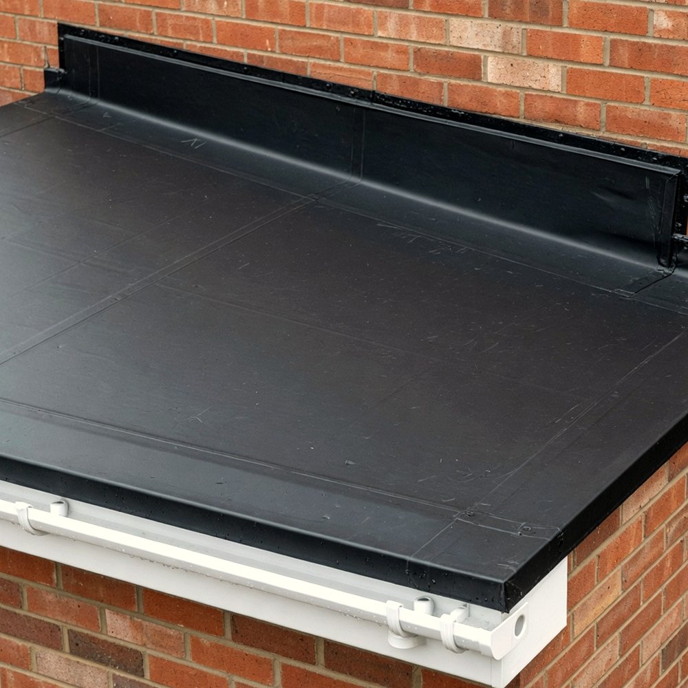 Black rubber flat roof membrane on a brick house extension, draining to a white gutter